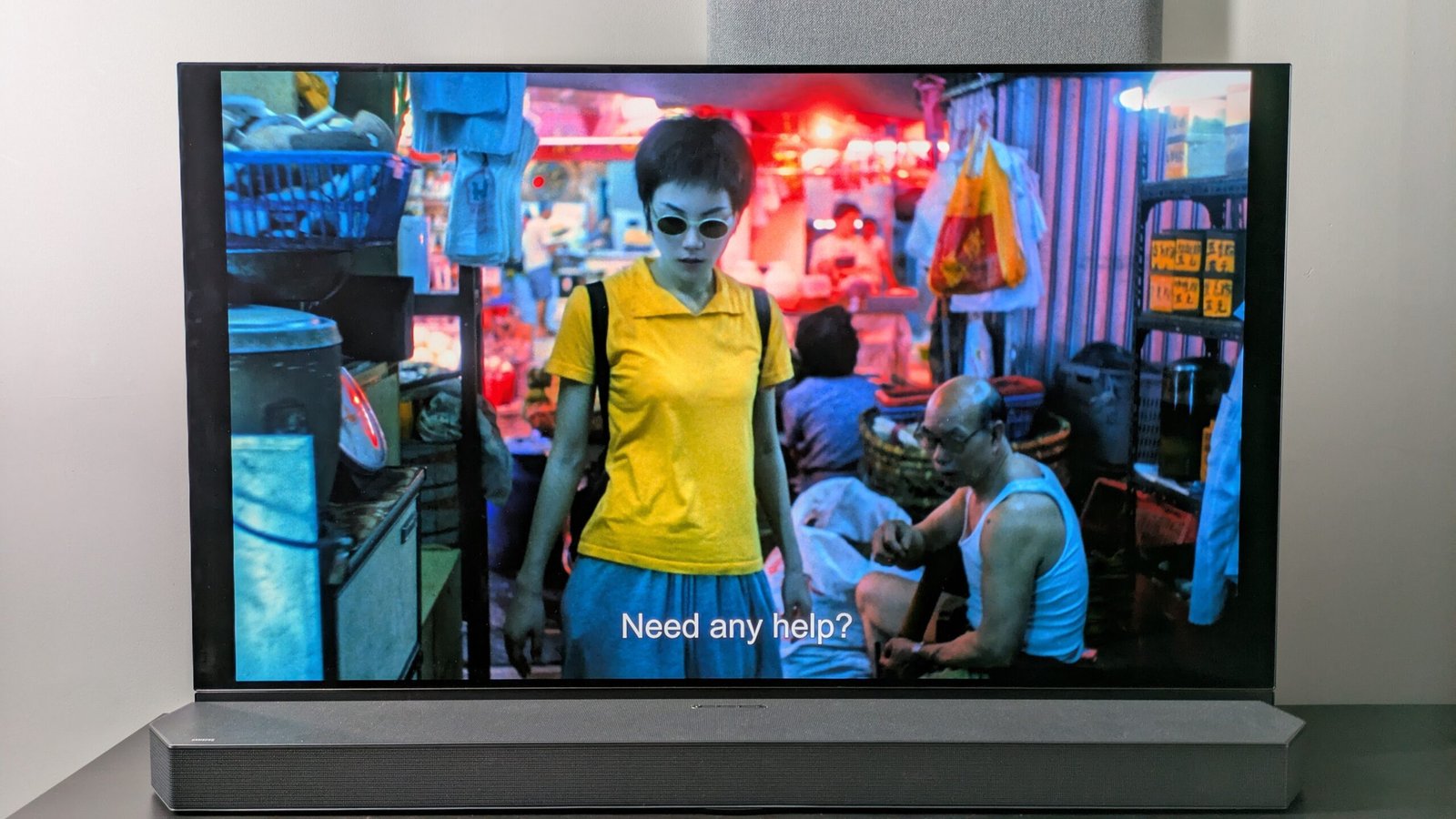 Panasonic OLED showing scene from Chungking Express with woman in yellow t shirt in kitchen area