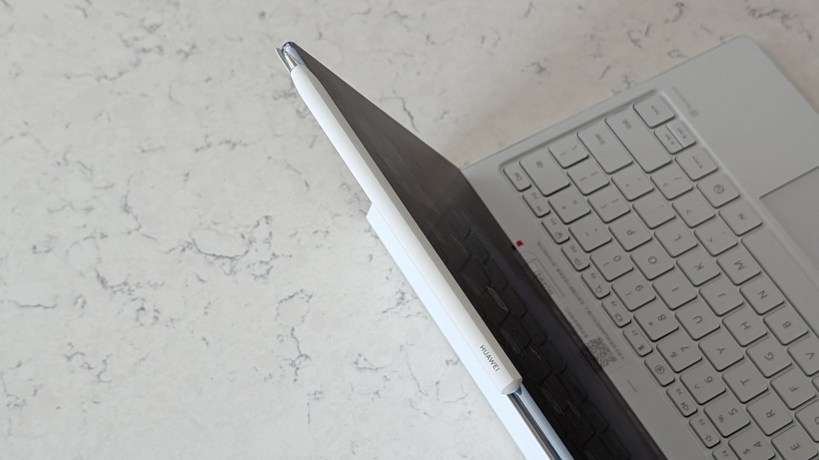 Photos of the Huawei MatePad Pro Max resting on a marble table